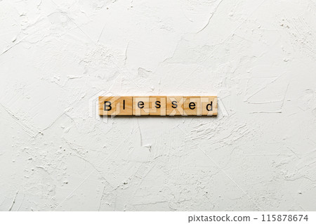 Blessed word written on wood block. Blessed text on table, concept Blessed word written on wood block. Blessed text on table, concept 115878674