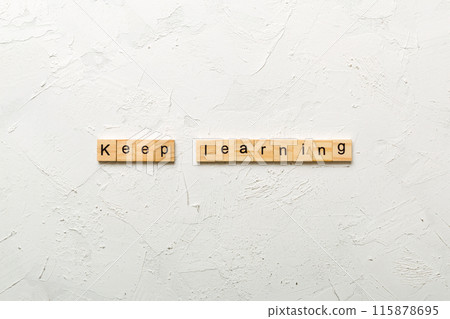keep learning word written on wood block. keep learning text on table, concept 115878695