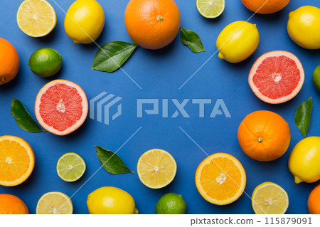 Flat lay of citrus fruits like lime, orange and lemon with lemon tree leaves on light colored background making a frame. Space for text healthy concept 115879091