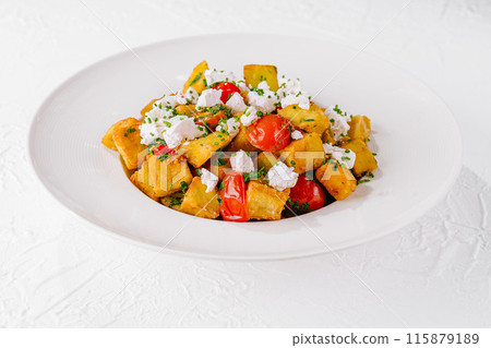 Fresh homemade polenta with tomatoes and feta Fresh homemade polenta with tomatoes and feta 115879189