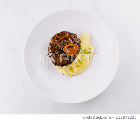 Gourmet steak with mashed potatoes on white plate 115879223
