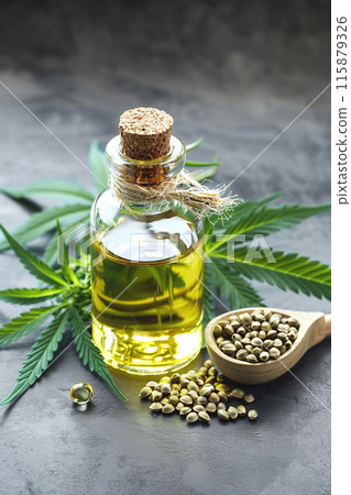 Hemp oil in glass bottle with hemp seeds and cannabis leaves, showcasing natural health and wellness benefits 115879326