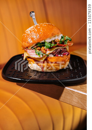 Gourmet burger with artisan toppings on a modern plate Gourmet burger with artisan toppings on a modern plate 115879339