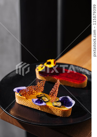 Gourmet dessert presentation on dark plate Gourmet dessert presentation on dark plate 115879399