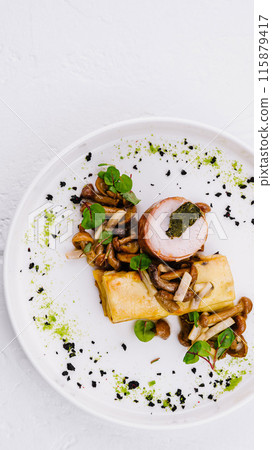 Gourmet stuffed chicken dish on elegant white plate 115879417