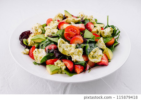 Fresh mixed salad with avocado and strawberries Fresh mixed salad with avocado and strawberries 115879418