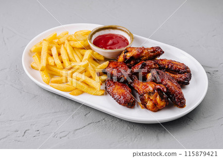 Crispy chicken wings and french fries with dipping sauce 115879421