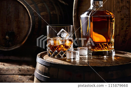 glass, bottle of whiskey and ice cubes on a wooden barrel 115879668