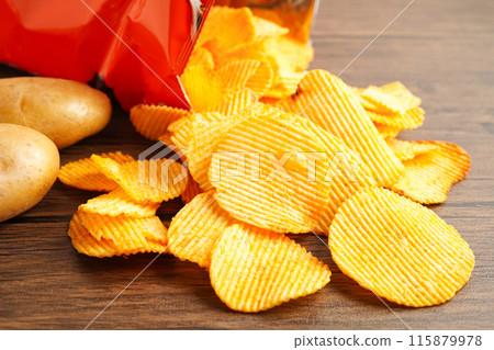 Potato chips fried snack fast food in open bag. Potato chips fried snack fast food in open bag. 115879978