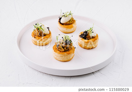 Gourmet vol-au-vent pastries on white plate Gourmet vol-au-vent pastries on white plate 115880029