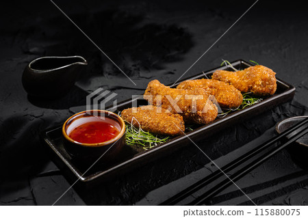 Crispy breaded chicken tenders with dipping sauce Crispy breaded chicken tenders with dipping sauce 115880075