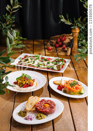 Gourmet salad trio on wooden table 115880076