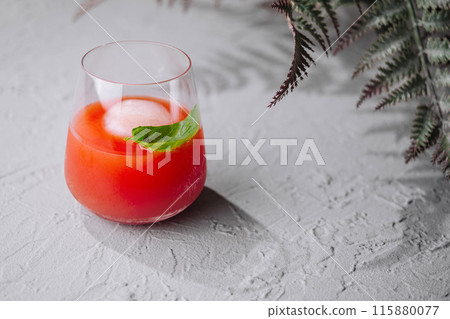 Refreshing tomato cocktail with basil garnish Refreshing tomato cocktail with basil garnish 115880077