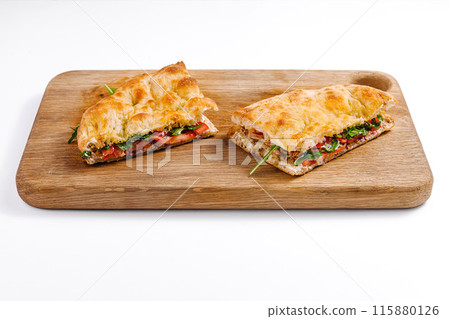 Fresh italian panini sandwich on wooden board Fresh italian panini sandwich on wooden board 115880126