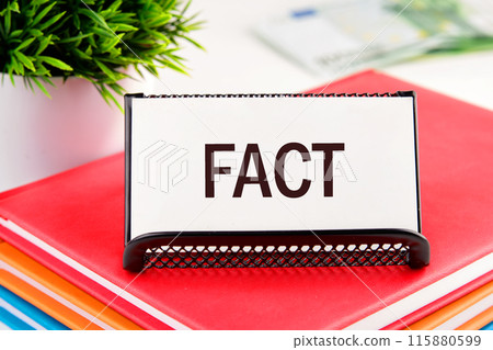Business concept. FACT word on a business card standing in a stand on a notepad 115880599