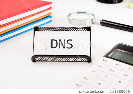DNS (Domain Name System) acronym. DNS on a business card in a stand on a white background DNS (Domain Name System) acronym. DNS on a business card in a stand on a white background 115880606