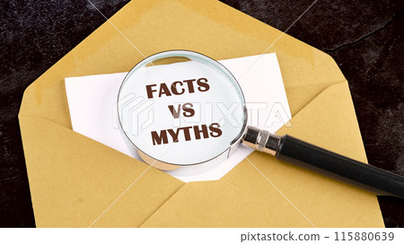 Business, financial and fact vs myth concept. Copy space. Concept words, symbol Fact vs myth on a white sheet of paper through a magnifying glass on the background of a postal envelope 115880639