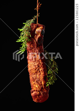 Homemade smoked pork ribs with juniper branches. 115881223