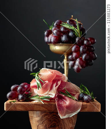 Prosciutto with grapes and rosemary. 115881273