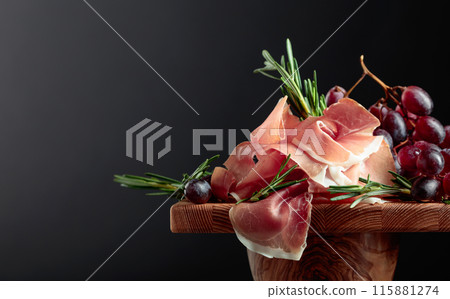 Prosciutto with grapes and rosemary. Prosciutto with grapes and rosemary. 115881274