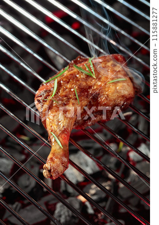 Chicken with rosemary on a grill. 115881277
