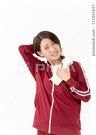 A woman in a jersey wiping sweat A woman in a jersey wiping sweat 115881657