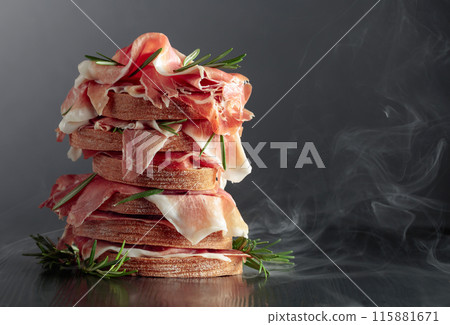 Italian prosciutto or Spanish jamon with bread and rosemary. 115881671