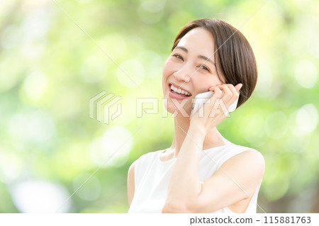 Middle-aged woman talking on the phone, fresh greenery 115881763