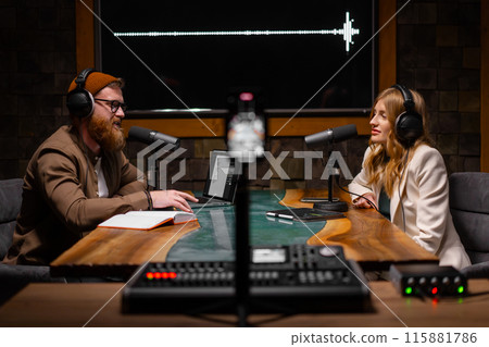 Joyful young stylish radio show hosts record fresh podcast episode in loft studio 115881786