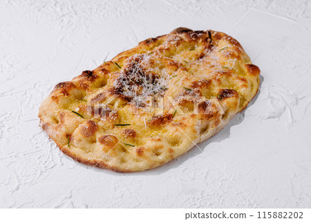 Freshly baked cheesy flatbread on white background 115882202