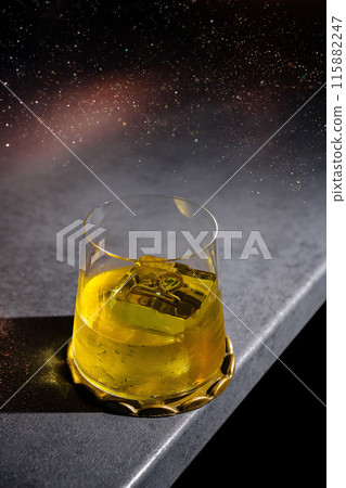 Golden whiskey with ice on dark background 115882247