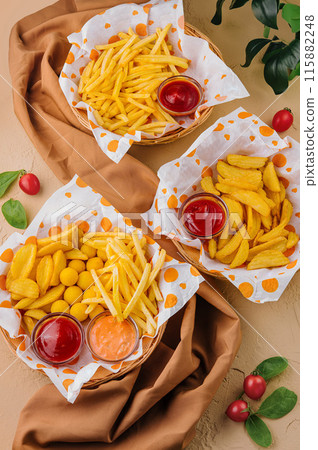 Assorted fried snacks with dipping sauces on table 115882248