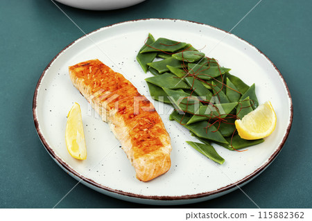 Grilled salmon with vegetable garnish. Grilled salmon with vegetable garnish. 115882362