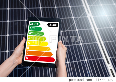 Hands with digital tablet on a background of solar panels 115882489