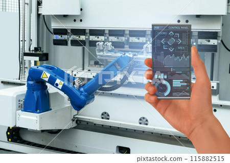 Engineer uses a futuristic transparent smartphone to control robots in a smart factory. Smart industry 4.0 concept Engineer uses a futuristic transparent smartphone to control robots in a smart factory. Smart industry 4.0 concept 115882515
