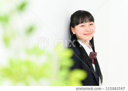 High school girl leaning against a wall, blurred front High school girl leaning against a wall, blurred front 115882547
