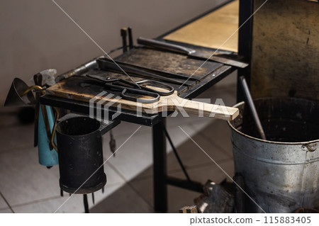 Tools are placed in a glass blowing workshop Tools are placed in a glass blowing workshop 115883405