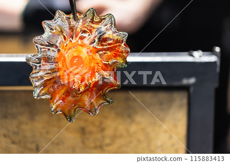 Molten glass in shape of a flower, close up Molten glass in shape of a flower, close up 115883413