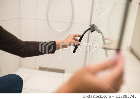 House wife cleaning the bathroom and a shower cabin 115883743