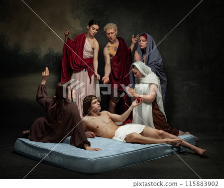 Man lies on mattress with crown of thorns, surrounded by five people in flowing robes, their expressions and gestures indicating concern and reverence. 115883902