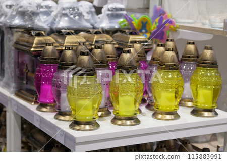 Memorial lamps of various colors are sold in store. Christian memorial lamps in shop. 115883991