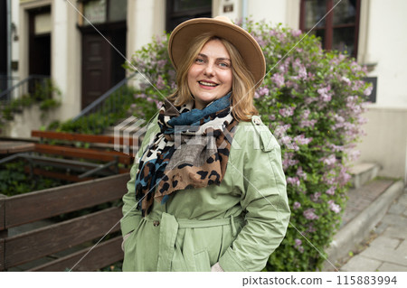 Attractive young smiling blonde 30s woman walking in autumn par wearing checkered coat, happy mood, fashion style trend Attractive young smiling blonde 30s woman walking in autumn par wearing checkered coat, happy mood, fashion style trend 115883994