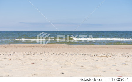 Baltic sea. Sand, sky, sea water and waves. The Baltic sea in the Kurshskaya Kosa in the Kaliningrad region.  115885025