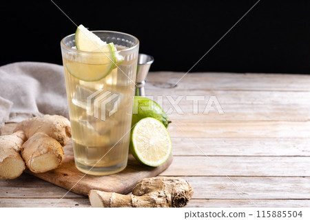 Fresh ginger ale drink in tall glass on wooden table Fresh ginger ale drink in tall glass on wooden table 115885504