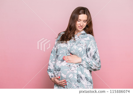 Pregnant Woman in Floral Dress Holding Belly Pregnant Woman in Floral Dress Holding Belly 115886074
