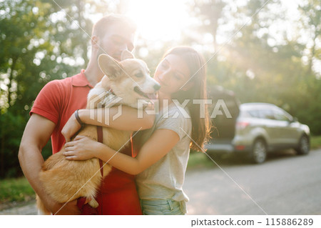 Young couple together with their beloved pet on walk. Domestic dog concept. Active lifestyle concept 115886289