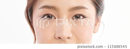 Close-up shot of beautiful Asian woman eyes on white background. Close-up shot of beautiful Asian woman eyes on white background. 115886543