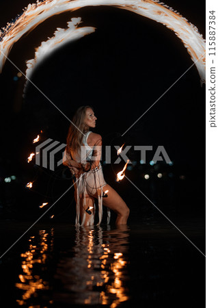 Caucasian woman dancing with fire in the water. Fire show at sea. Acrobatics on the beach. Yoga and relaxation at sunset. Spectacular circus performance. model body. High quality FullHD footage.  115887384