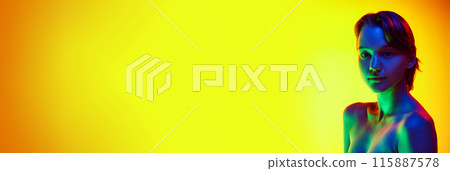 Calm woman with short brown hair in neon light against gradient studio background with negative space to insert text. 115887578