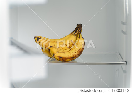 A bunch of ripe bananas in an empty refrigerator. A bunch of ripe bananas in an empty refrigerator. 115888150